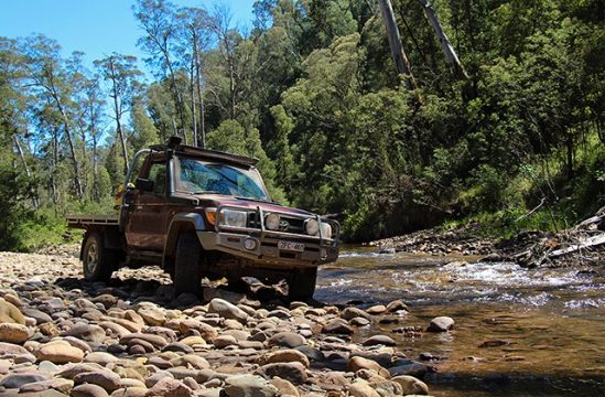 LandCruiser 79 Series tray parked on creek in the Victorian high country.